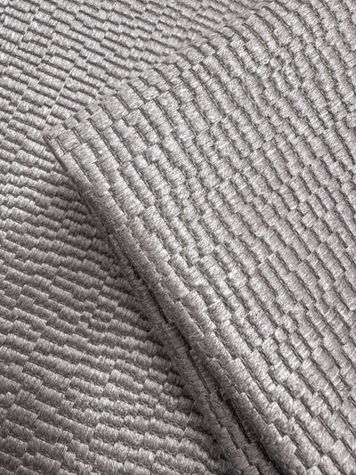 Close-up of Super Cheap Fabrics' Upholstery Jacquard - Oscar Dusk (142cm), a heavyweight silver fabric featuring a shiny, textured surface with a raised grid pattern that catches the light, emphasizing its woven structure and metallic sheen.
