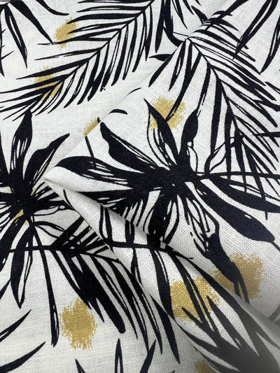 Close-up of a printed linen fabric featuring a tranquil palm-like pattern, designed to evoke a sense of holiday, calm, and serenity. This premium material is a blend of natural fibers, combining the durability of linen with the softness of cotton, ideal for creating luxurious and comfortable home textiles or fashion pieces.