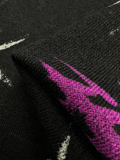 Close-up of Super Cheap Fabrics' Textured Knit - Bamboo, 145cm. This medium-weight fabric features an abstract pattern in black, purple, and white. It showcases detailed stitching with vibrant colors and a generous stretch for comfort.