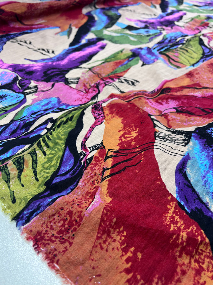 The Printed Linen - Aurora by Super Cheap Fabrics features a vibrant abstract pattern with bold, colorful shapes in purple, blue, red, green, and orange. This 137cm wide fabric is perfect for artistic garments with its dynamic lines and brushstroke textures.