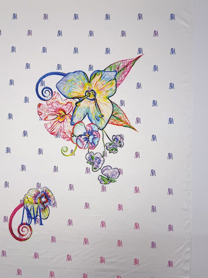 Super Cheap Fabrics' Viscose Knit - Orchid - 135cm is a white, breathable knit with a blue, red, and purple "SM" pattern, highlighted by hand-drawn orchids and leaves for added comfort and style.