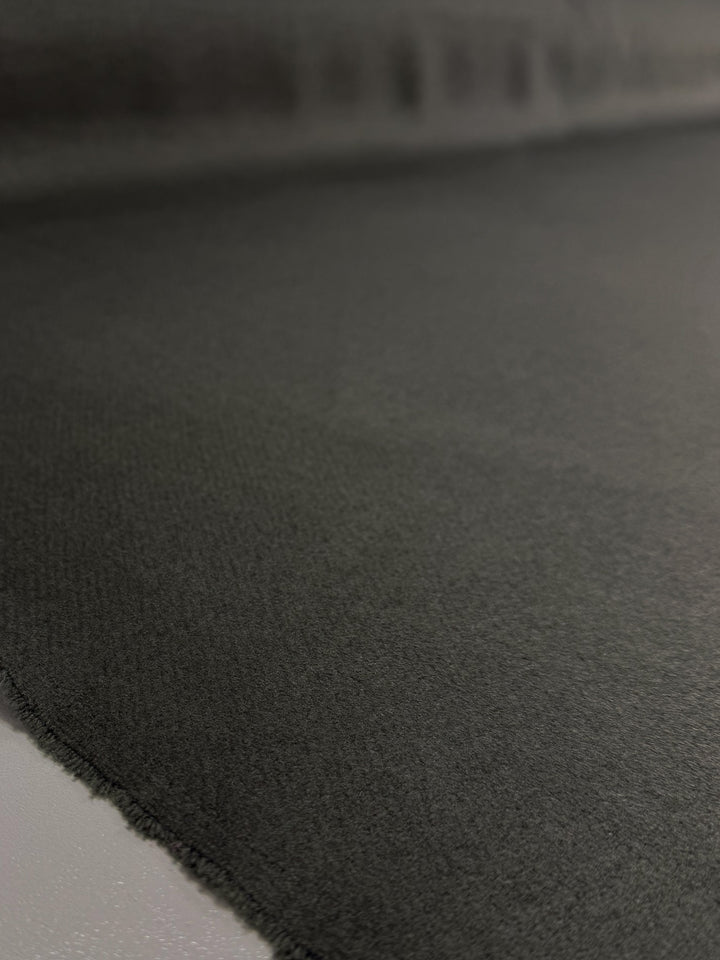 A close-up of Super Cheap Fabrics' Wool Cashmere in Agave Green (150cm), laid flat to display its textured, extra heavy weight surface and subtly frayed edge.
