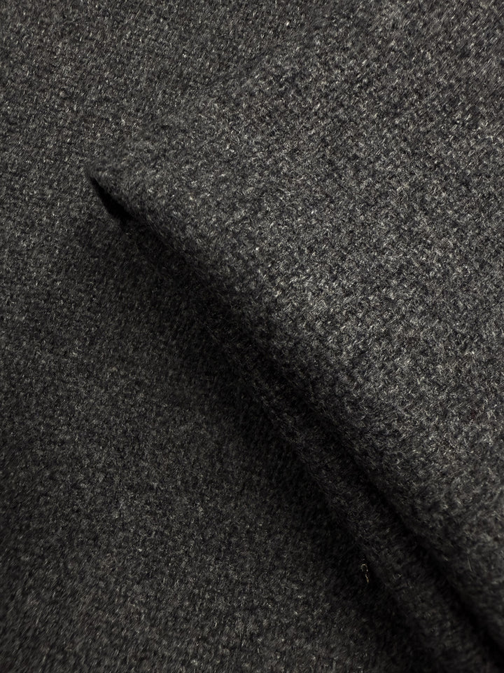 Close-up of Super Cheap Fabrics' Hopsack Wool in Charcoal (150cm), highlighting its coarse, textured weave and soft, slightly fuzzy surface.
