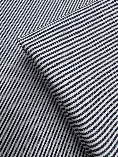 Close-up of two overlapping pieces of Super Cheap Fabrics’ Designer Cotton - Pintrack (150cm), showing black and white diagonal stripes at contrasting angles.