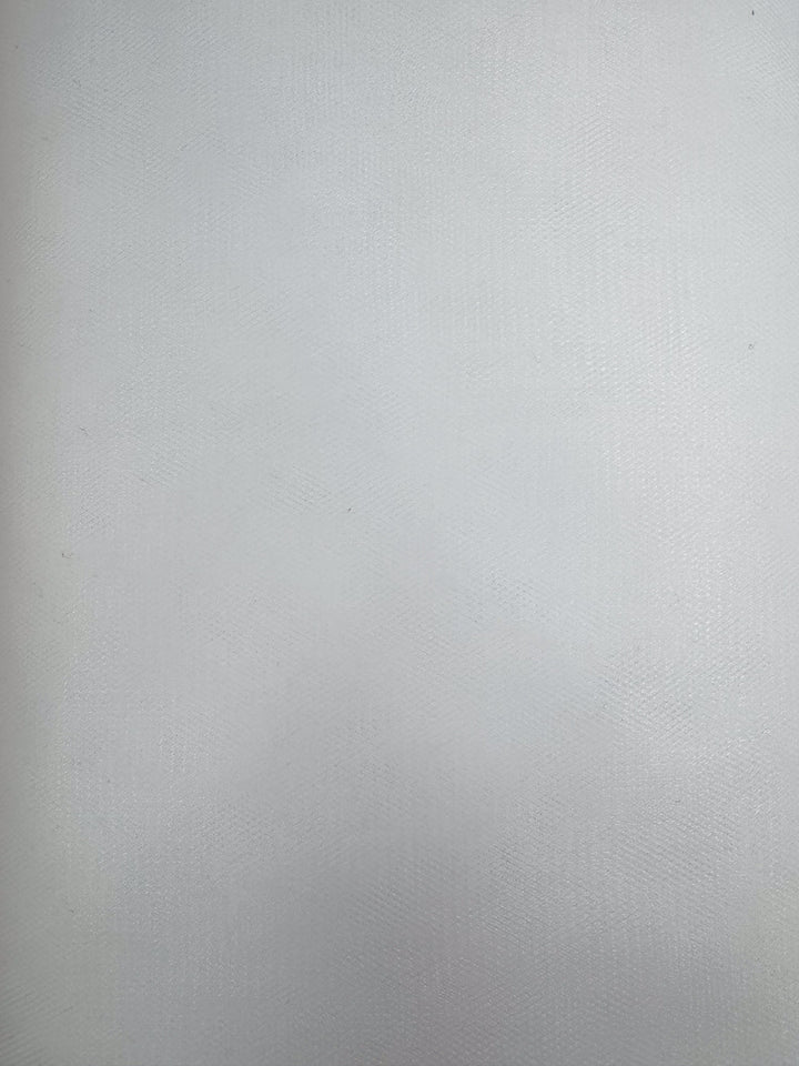 Close-up of Super Cheap Fabrics' Soft Tulle in White (150cm): a plain white surface with subtle, fine lines and a soft sheen, similar to tulle fabric used in bridal veils and costumes. No distinct patterns or objects are visible.