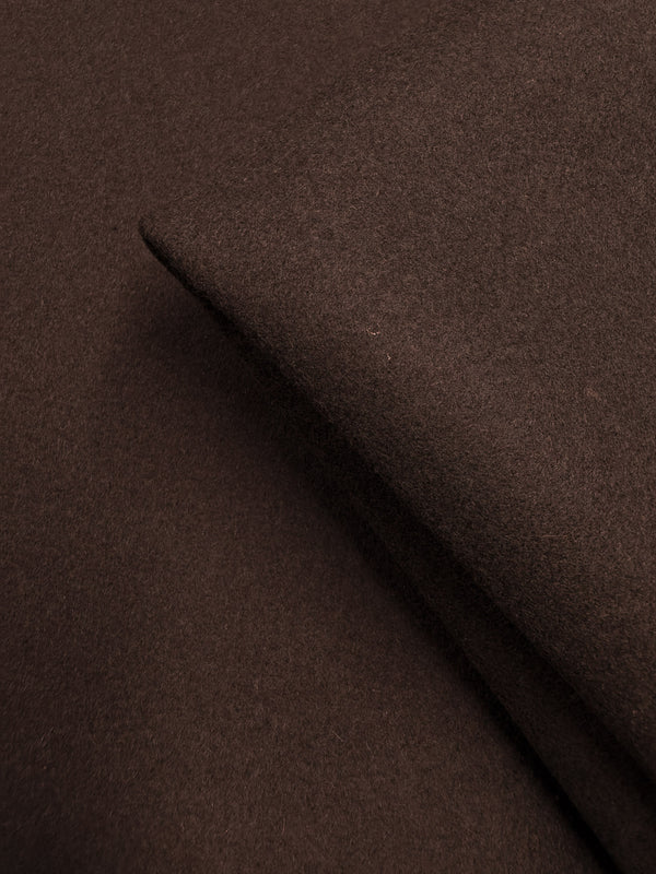 A close-up of folded Melton Wool - Black Coffee (150cm) by Super Cheap Fabrics highlights its soft, smooth texture and rich color—ideal for luxurious outerwear.