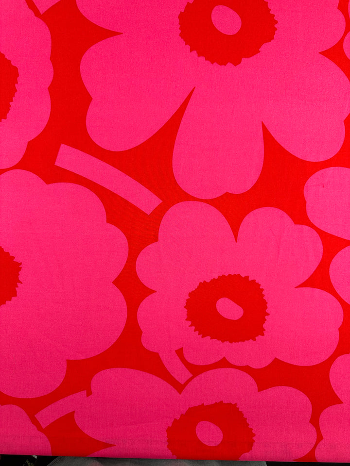 Designer Rayon - Jam Poppy by Super Cheap Fabrics features a bold pink and red floral pattern with stylized flowers on quality rayon, perfect for creating playful, eye-catching designs. Width: 145cm.