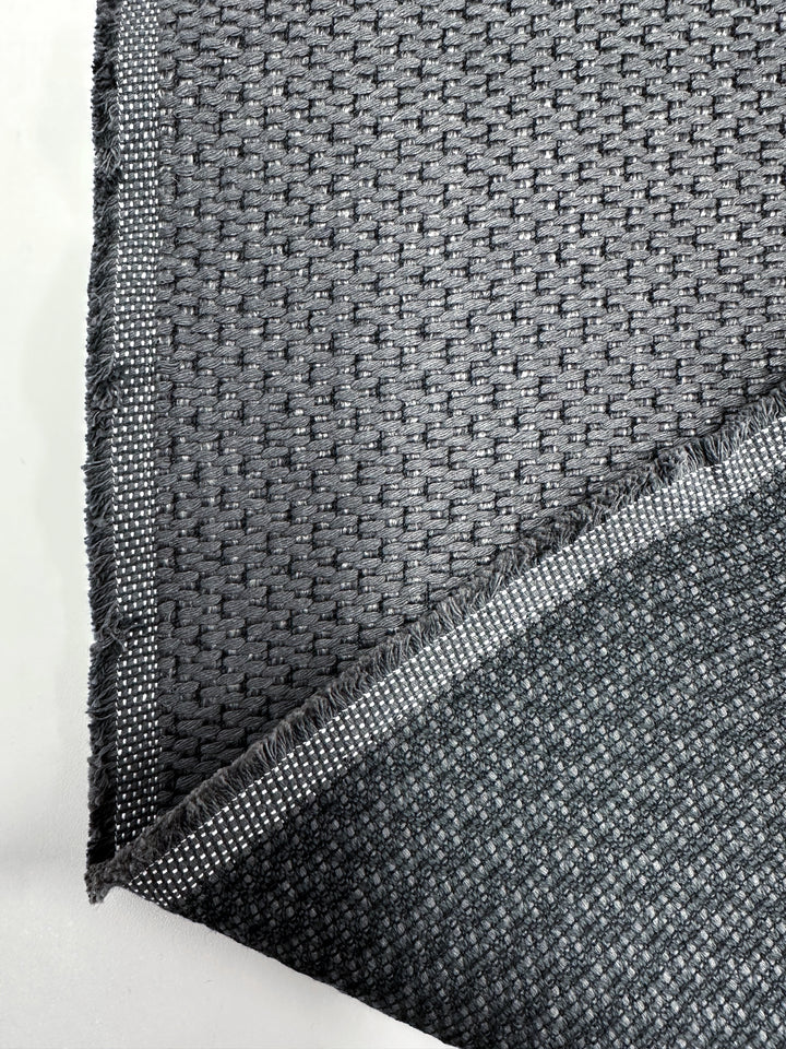 A close-up of two overlapping pieces of Basketweave Upholstery - Bacchus Blue Steel (142cm) by Super Cheap Fabrics, highlighting its detailed weave and frayed edges—ideal for premium Australian high-end upholstery projects.