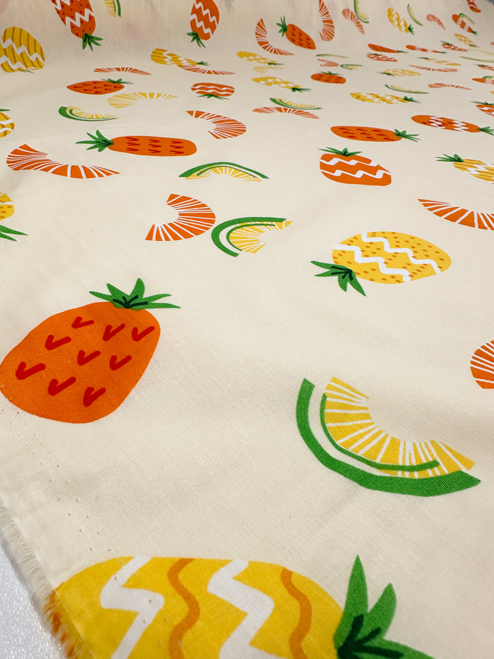 This lightweight fabric, part of the Super Cheap Fabrics collection, features a printed cotton design titled "Summer" on an elegantly flat 150cm surface. The crisp white background is beautifully adorned with vibrant fruit motifs, showcasing strawberries, pineapples, and watermelon slices in lively hues of orange, yellow, and green. The natural cotton fibers provide a soft touch to this captivating visual ensemble.