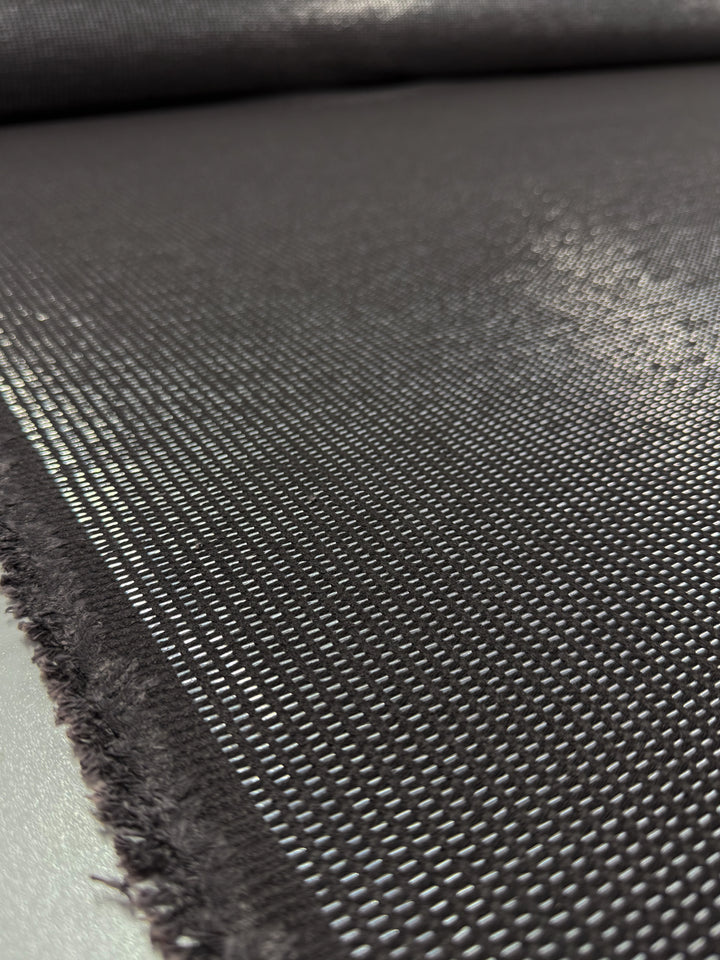 A close-up of Super Cheap Fabrics’ Linen Blend - Silver Dash (135cm) shows its dark, grid-like weave and frayed edges. The unique texture and pattern make it perfect for upholstery projects.