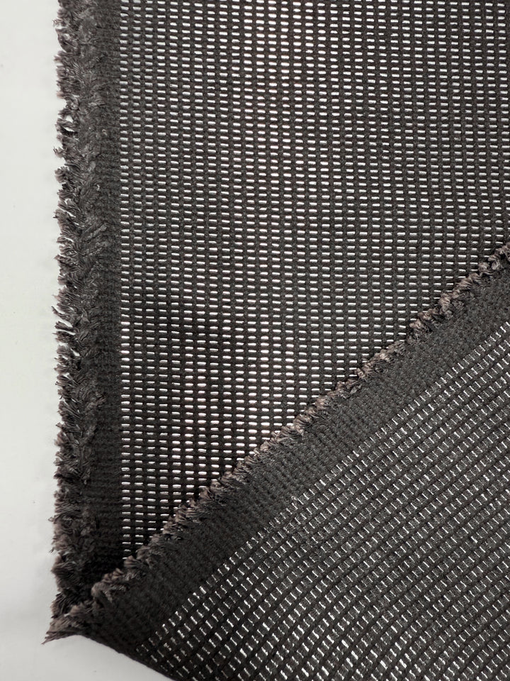 Close-up of Super Cheap Fabrics' Linen Blend - Silver Dash (135cm): black mesh with a grid pattern and two overlapping layers, slightly frayed edges, on a plain white background. Ideal for upholstery.