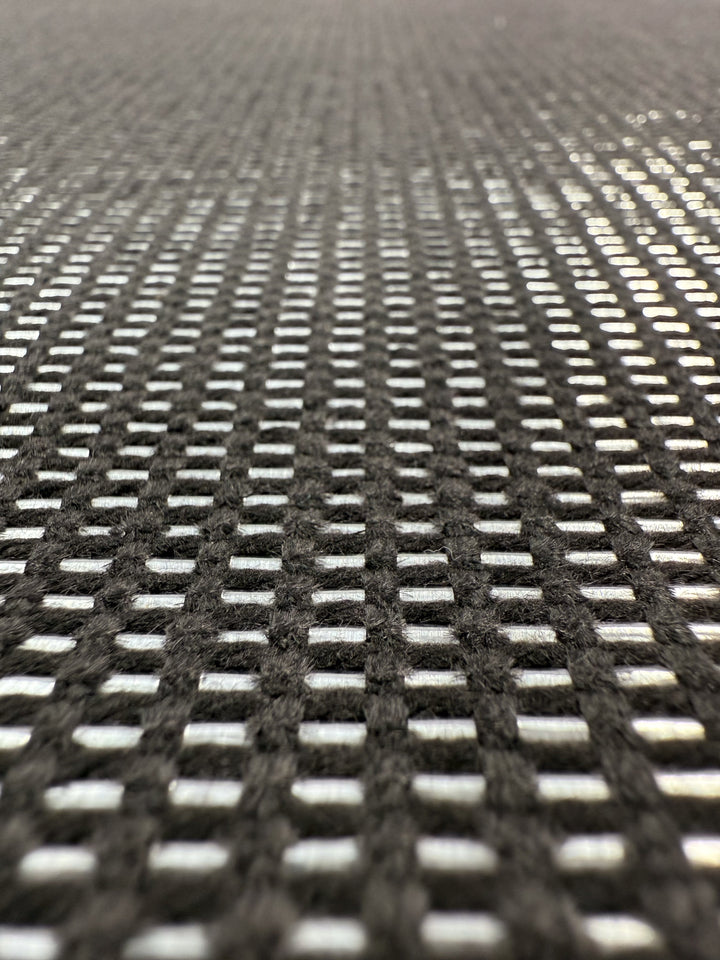 Close-up of Super Cheap Fabrics’ Linen Blend - Silver Dash (135cm), highlighting its grid-patterned texture with silver dashes and white accents, captured from a low angle to showcase the fabric’s luxury detail and rhythmic depth.