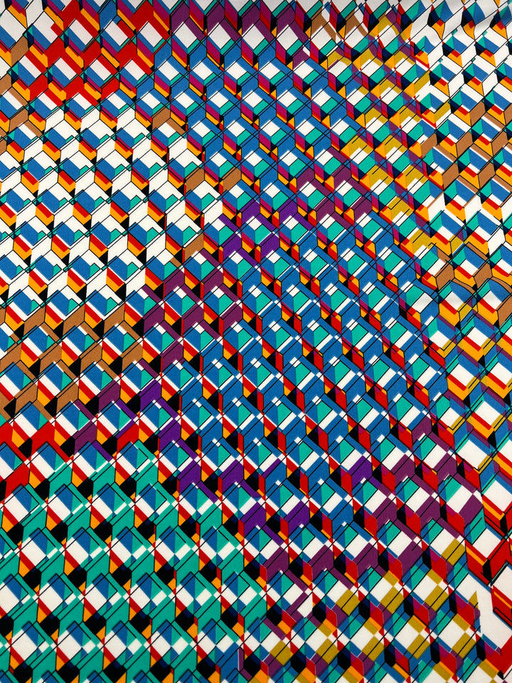 A dynamic, abstract geometric pattern showcasing a variety of interlocking cubes in a vibrant spectrum of colors—red, yellow, blue, green, and purple—is prominently featured on Super Cheap Fabrics' Printed Lycra - Rubex. This 150cm wide fabric blends medium-weight Polyester/Spandex to create a stunning three-dimensional effect with seamless color transitions.