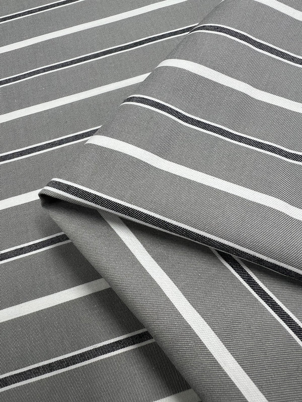 A close-up of two overlapping pieces of Super Cheap Fabrics' Cotton Twill - Monochrome - 153cm reveals lightweight cotton fabric with white and black horizontal stripes. The fabric appears smooth and neatly arranged, showcasing a simple, elegant pattern suitable for dresses or pants.