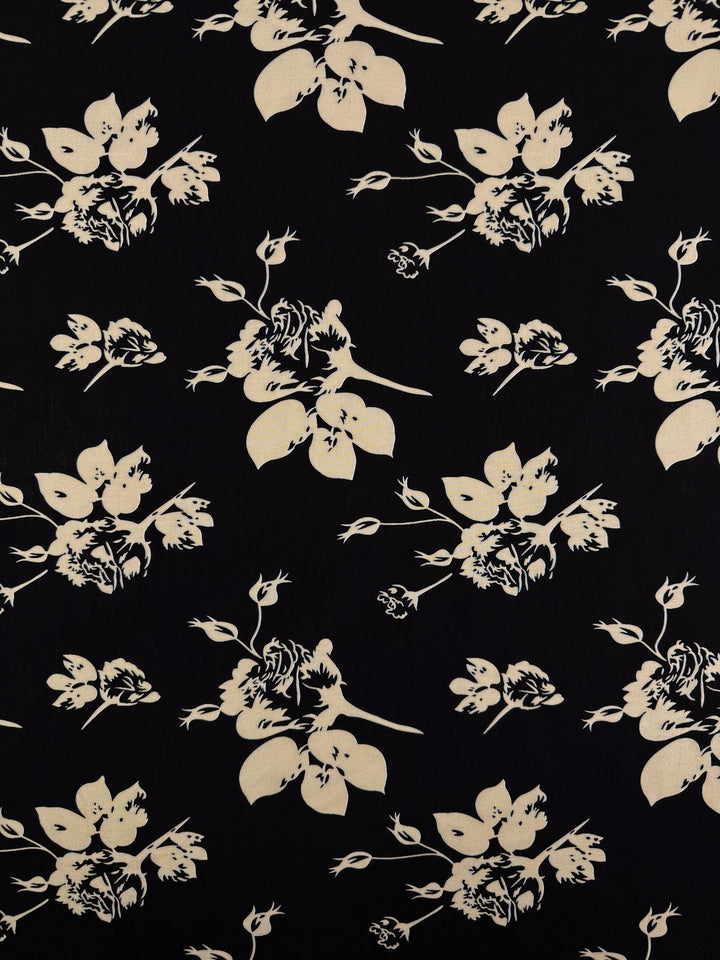 Designer Rayon - Moonflower Silhouette by Super Cheap Fabrics features cream floral silhouettes on a solid black background, creating a striking abstract flower and leaf pattern—ideal for vibrant prints. Width: 147cm.