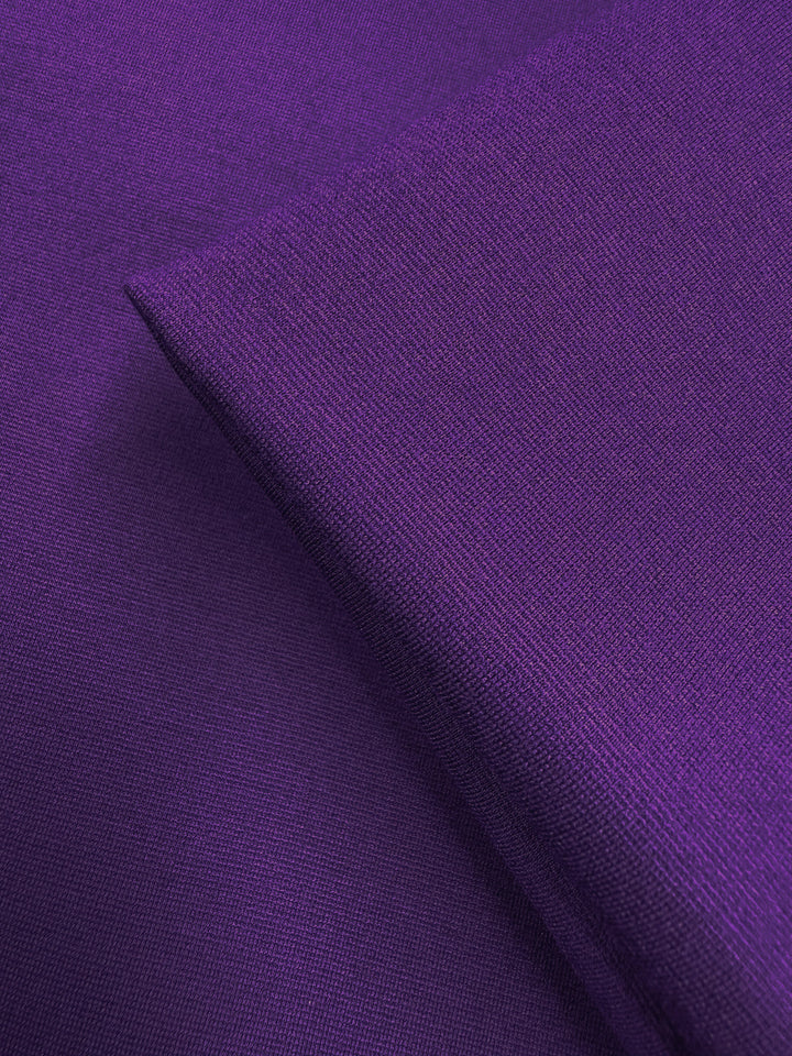 Close-up of two pieces of Milano Ponte - Violet Indigo - 165cm by Super Cheap Fabrics, overlapping to showcase their smooth, finely woven texture and rich purple color—perfect for stretch suiting and fitted dresses.