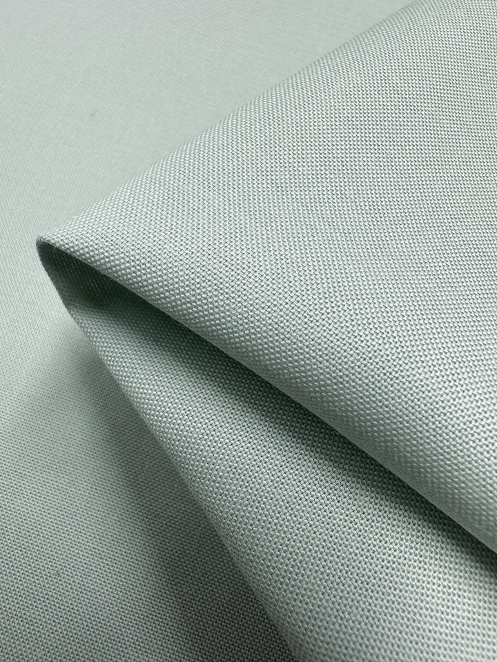 A close-up of neatly folded fabric with a textured, woven appearance. This lightweight linen blend "Blue Flower" fabric by Super Cheap Fabrics is smooth and seems durable, possibly suitable for upholstery or clothing. Width: 140cm.