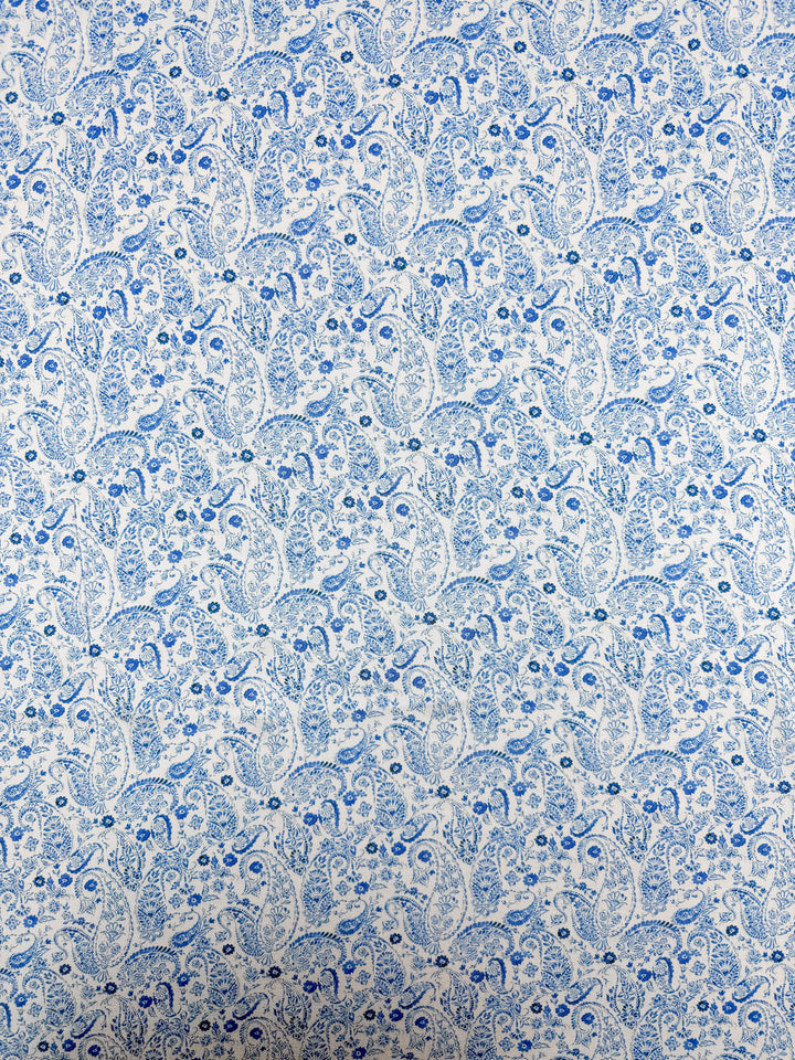 Super Cheap Fabrics’ Mercerised Rayon - Delft Vine - 150cm features a silky soft, lightweight fabric with a densely packed blue paisley pattern of floral and leaf motifs on white. Perfect for elegant, airy garments.