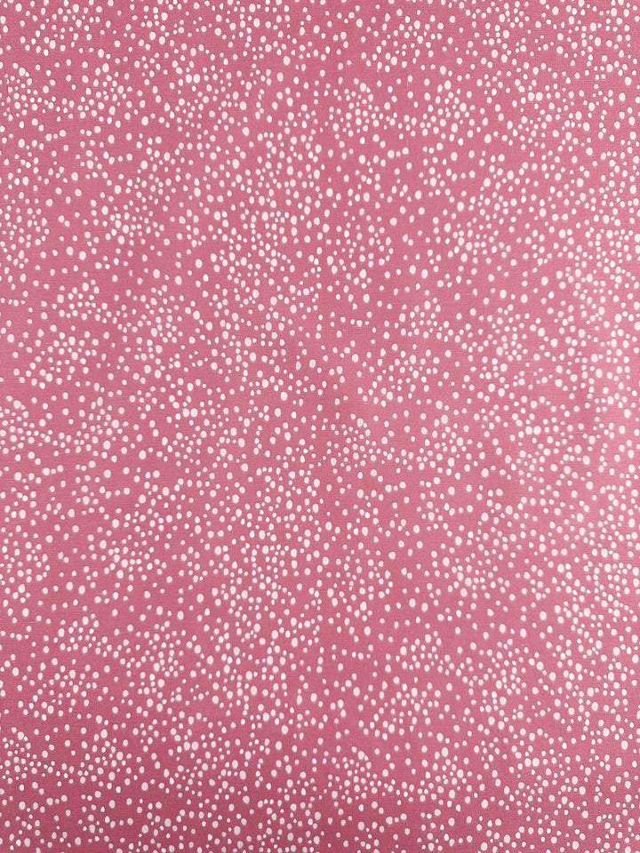 The Linen Blend - Spotty fabric from Super Cheap Fabrics features small white dots on a Mauveglow pink background, resembling stars or snowflakes. The dots vary slightly in size, are evenly distributed across the 140cm fabric, and create a textured effect perfect for home decor.