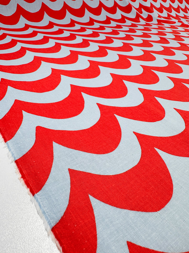 The Linen Blend - Smile - 136cm fabric by Super Cheap Fabrics features a Cherry Tomato red and white wave-like pattern that creates a dynamic optical illusion, perfect for adding flair to home decor.