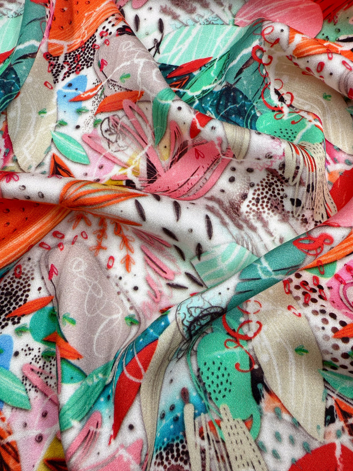 Mercerised Rayon - Electric Orchard by Super Cheap Fabrics is a colorful, silky soft fabric with vibrant red, green, pink, orange, and black abstract patterns on lightweight rayon (148cm), featuring shapes and lines for added texture.