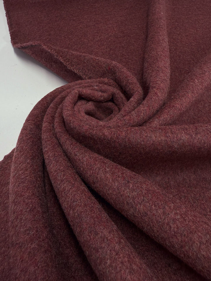 A close-up of Super Cheap Fabrics’ Wool Cashmere - Mahogany Marle - 154cm in a swirl on white showcases its rich texture and luxurious softness.