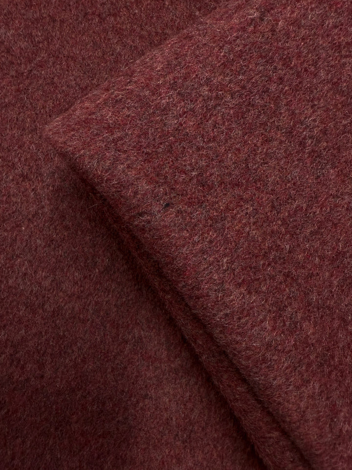 Close-up of two overlapping pieces of Super Cheap Fabrics' Wool Cashmere - Mahogany Marle (154cm), highlighting the soft, fuzzy texture and luxurious feel of the reddish-brown fabric.