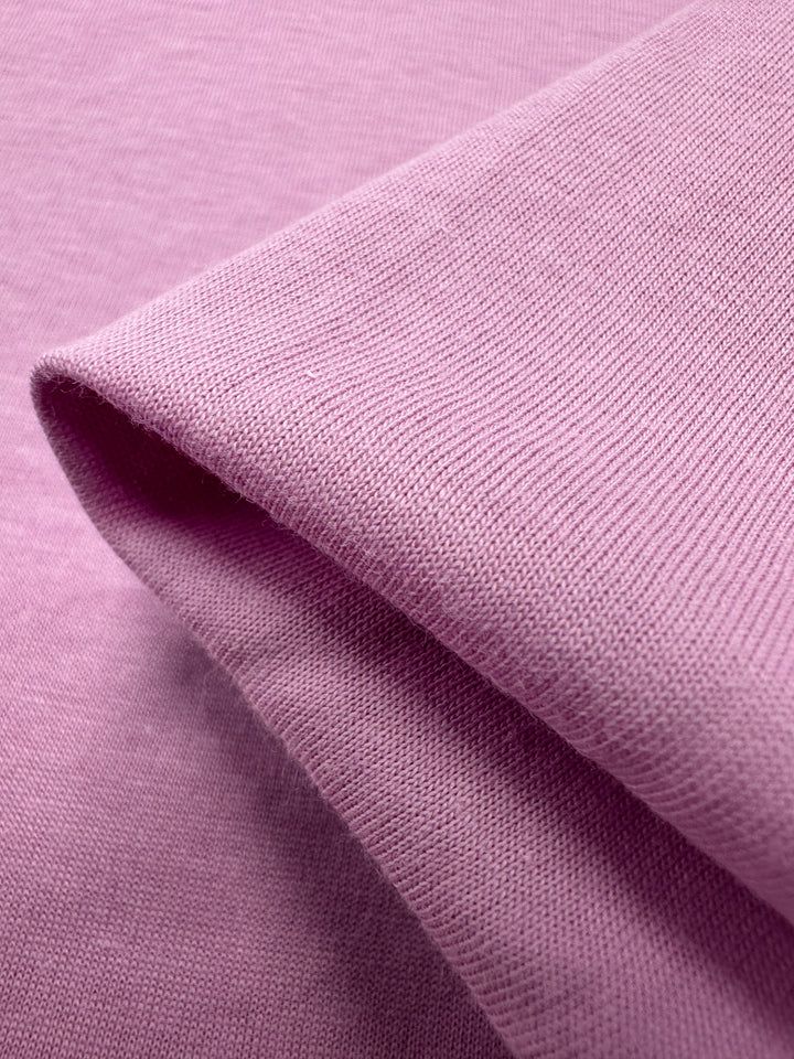 A close-up of Super Cheap Fabrics' Cotton Jersey in pastel lavender shows its fine knit texture and smooth surface, similar to delicate jersey fabric. Width: 160cm.