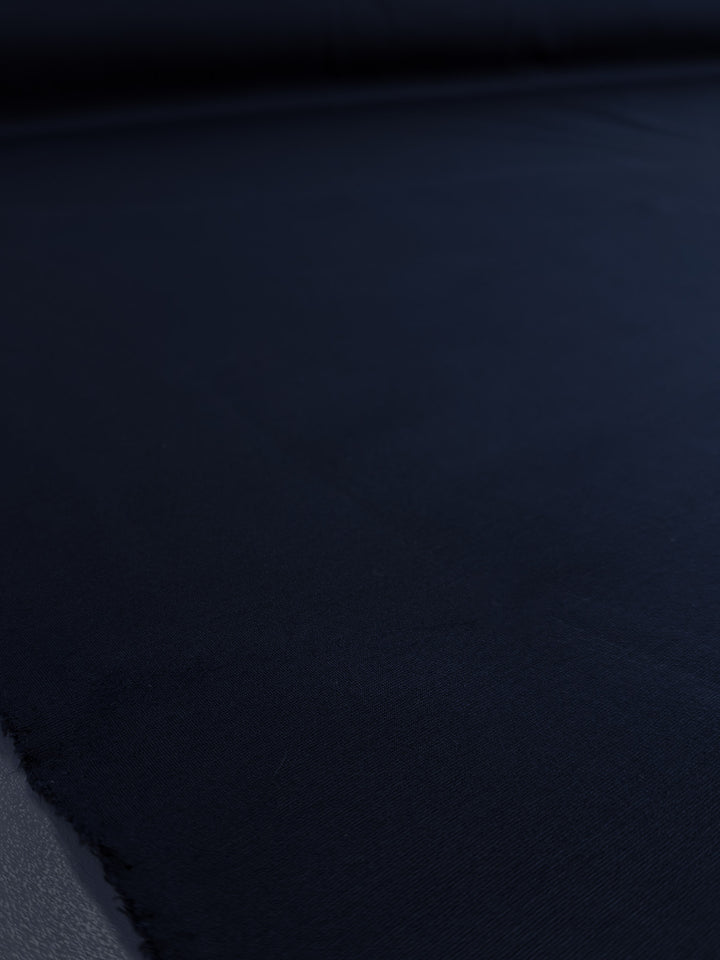 A close-up of Super Cheap Fabrics' Milano Ponte in Mood Indigo (160cm wide) highlights its smooth, heavyweight ponte fabric and subtle surface texture.