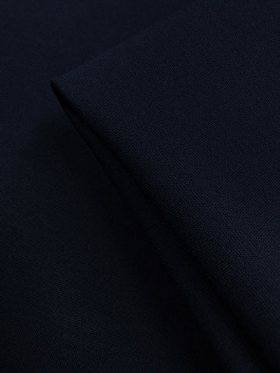A close-up of Super Cheap Fabrics' Milano Ponte in Mood Indigo (160cm), showcasing its dark navy hue, smooth yet textured surface, and subtle weave for a soft, structured look.