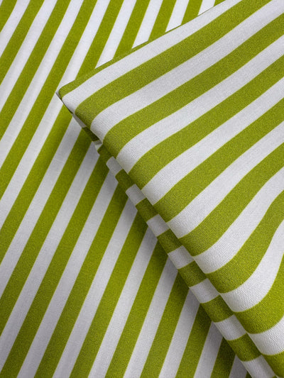 Super Cheap Fabrics' Printed Rayon - Lime Pop Stripe (140cm) features green and white diagonal stripes in a bold, modern pattern. This lightweight fabric is perfect for crisp, contemporary designs.