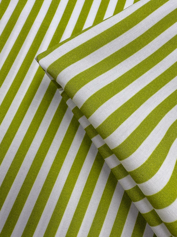 Super Cheap Fabrics' Printed Rayon - Lime Pop Stripe (140cm) features green and white diagonal stripes in a bold, modern pattern. This lightweight fabric is perfect for crisp, contemporary designs.