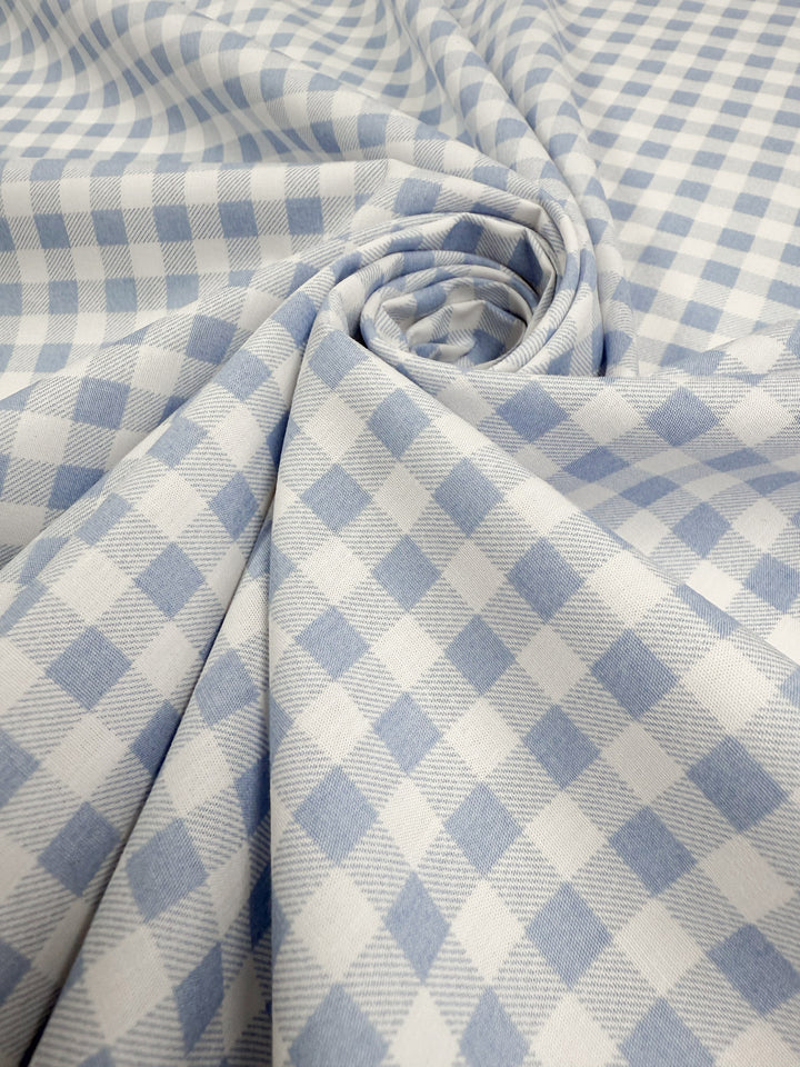 Close-up of Super Cheap Fabrics’ Linen Blend - Powder Blue Picnic (140cm), a soft blue checkered fabric with gentle folds and subtle sheen—perfect as a lightweight linen blend for summer jackets.