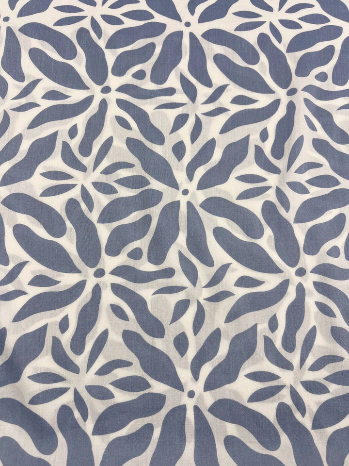 The Designer Rayon by Super Cheap Fabrics features an abstract leaf pattern in grayish-blue, elegantly arranged in a floral motif on a white background, offering versatility. Width: 140cm.