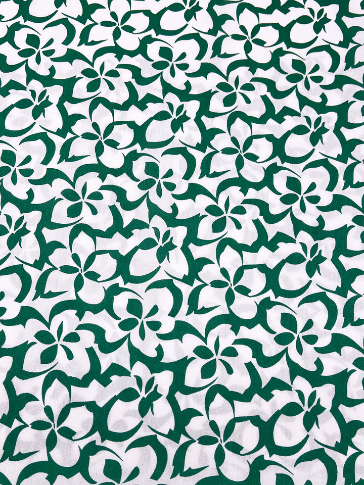 The Designer Rayon - Green Bee - 140cm from Super Cheap Fabrics features intricate white and green floral patterns in a striking, symmetrical design, enhancing the versatile fabric with vibrant prints.