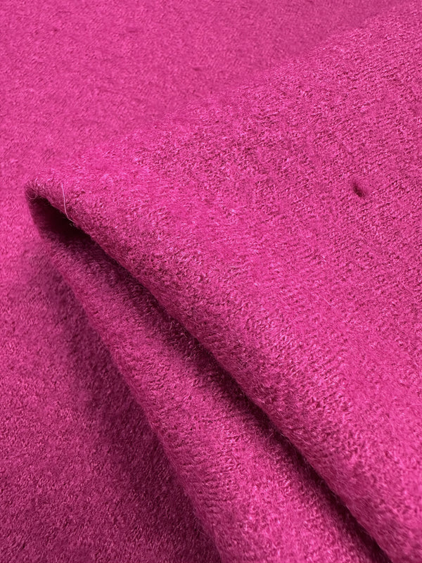 Close-up of Super Cheap Fabrics' Boiled Wool in Fuchsia Red, 140cm wide. The heavy-weight wool-viscose blend features a soft, textured surface with slight folds, highlighting its plush, cozy appearance.