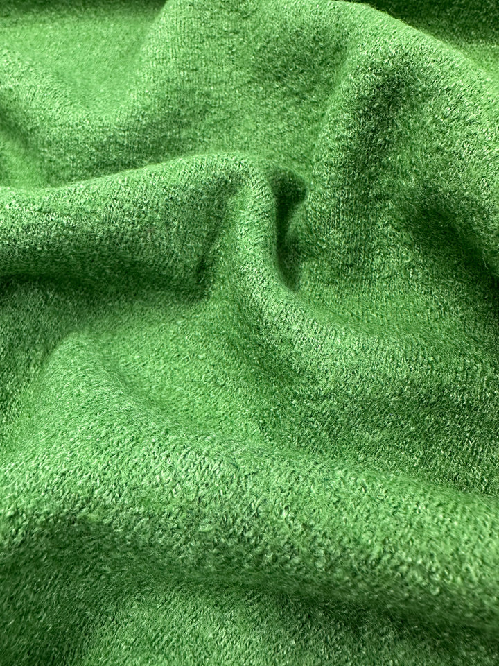 Close-up of the Boiled Wool - Meadow Green fabric by Super Cheap Fabrics, featuring a soft, textured surface with gentle folds and a luxurious wool-viscose blend.