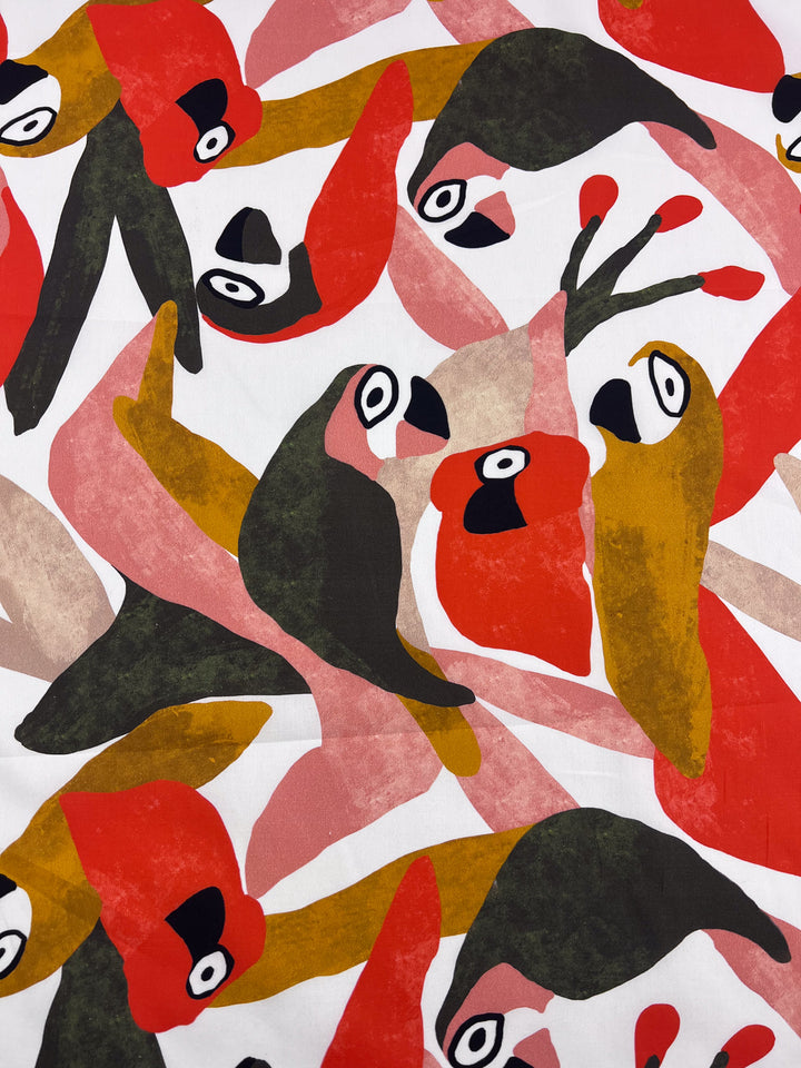 Super Cheap Fabrics' Printed Cotton - Tucan - 150cm features stylized birds in red, green, orange, and beige. Crafted from lightweight natural cotton, the overlapping birds form a vibrant and dynamic abstract pattern on a white background.