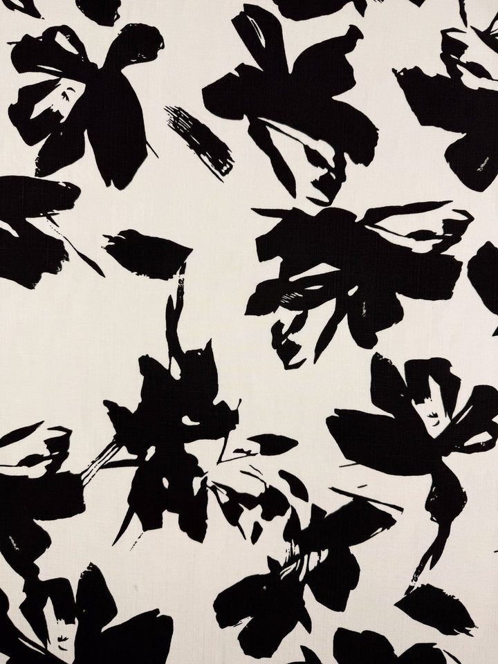 Bamboo Rayon - Jet Bloom by Super Cheap Fabrics features bold black abstract florals on a white background, offering a high-contrast, modern art look. At 150cm wide, it’s ideal for beginner-friendly sewing projects.