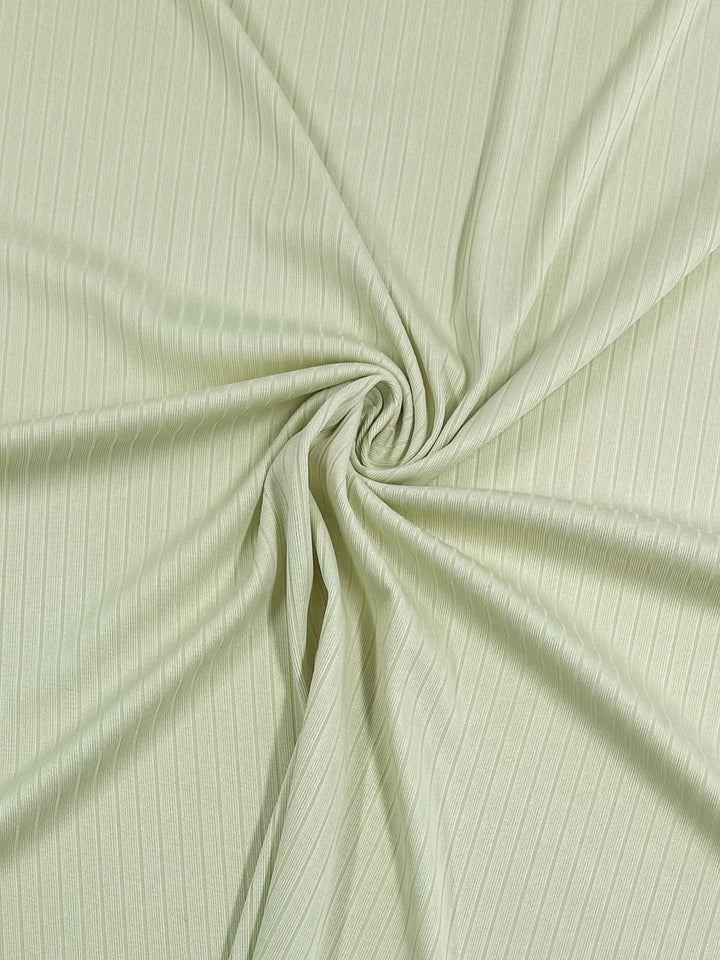 The Super Cheap Fabrics Rib Knit in Sylvan Green (175cm) showcases a spiral pattern with soft, radiating folds. This medium-weight, textured knit provides stretch and comfort, ideal for adding depth and dimension to garments.