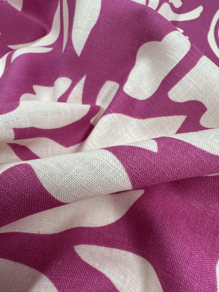 Close-up of Super Cheap Fabrics' Linen Blend in Rose Violet (138cm). The lightweight material features bold abstract patterns with gentle folds, suggesting a breathable, textured surface perfect for comfort.