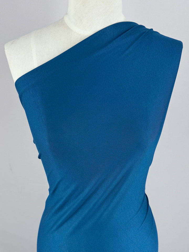A mannequin displays a stunning bodycon dress in sleek Lyons Blue, crafted from Super Cheap Fabrics' stretchy Cotton Lycra (150cm).