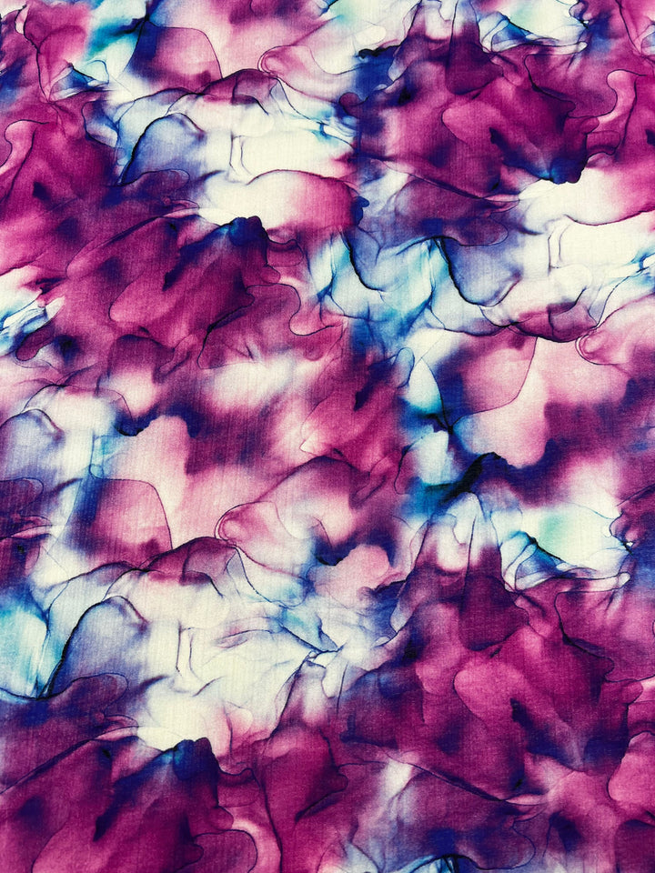 Explore the Designer Cotton - Celeste by Super Cheap Fabrics, a luxurious fabric featuring an abstract watercolor pattern in shades of pink, purple, blue, and white. The soft and overlapping hues create a fluid and textured appearance, ideal for your high-end sewing projects. With a width of 150 cm, it provides ample material for creative endeavors.