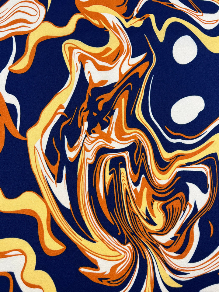 Experience the dynamic flow and bold contrasts of Super Cheap Fabrics' Printed Crepe - Potion. This luxurious fabric, with swirling patterns of orange, yellow, white, and deep blue on a 150cm width, evokes waves of movement like a dance in the breeze.