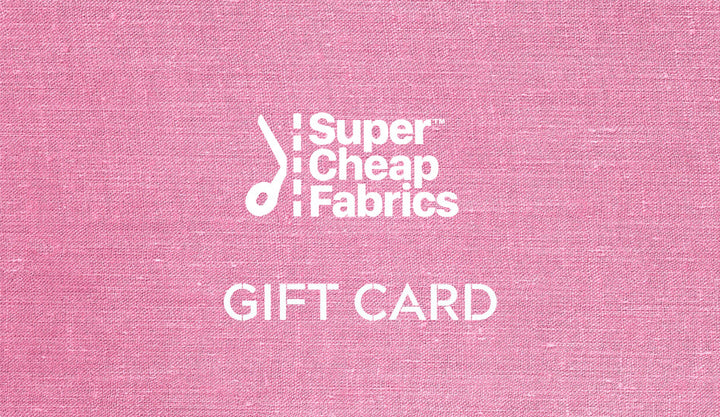 A pink fabric texture background showcases the white text "Super Cheap Fabrics" above the words "Gift Vouchers," perfect for any sewing enthusiast. The "Super Cheap Fabrics" text includes a small musical note graphic to the left, and you can easily redeem online for added convenience.